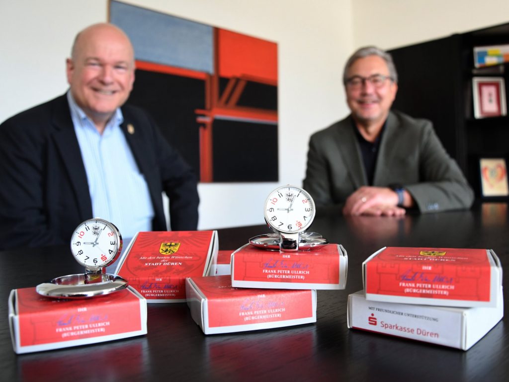 Bürgermeister Frank Peter Ullrich (l.) und der Vorstandsvorsitzende der Sparkasse Düren, Uwe Willner, präsentieren die neue Stadt-Uhr. Sie soll zu verschiedenen Anlässen als Präsent an Ehrenamtler verteilt werden.