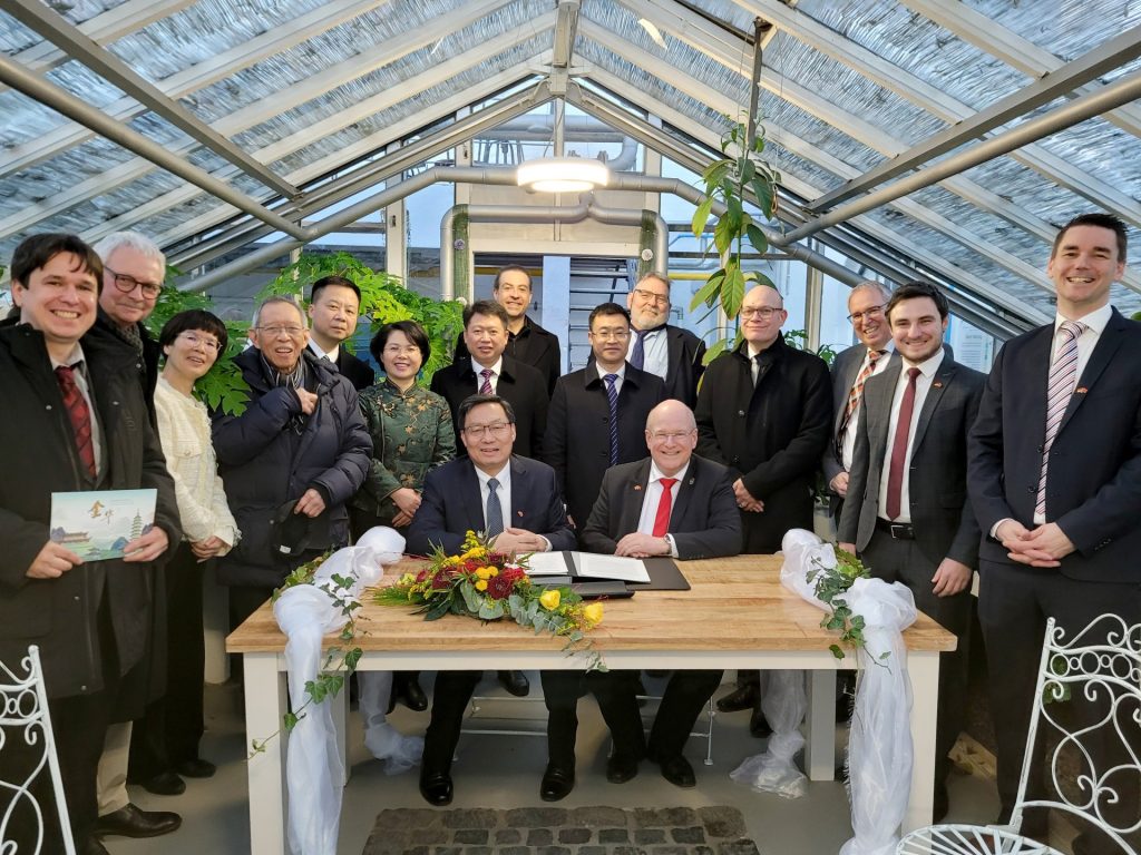 Gruppenfoto bei der Unterzeichnung des Memorandums. Am Tisch sitzend Bürgermeister Frank Peter Ullrich (re.) und Parteisekretär Zhu Chonglie (li.)